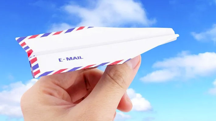 A paper aeroplane (held between a human's finger and thumb ready for launch) with the word 'E-MAIL' on its right hand wing